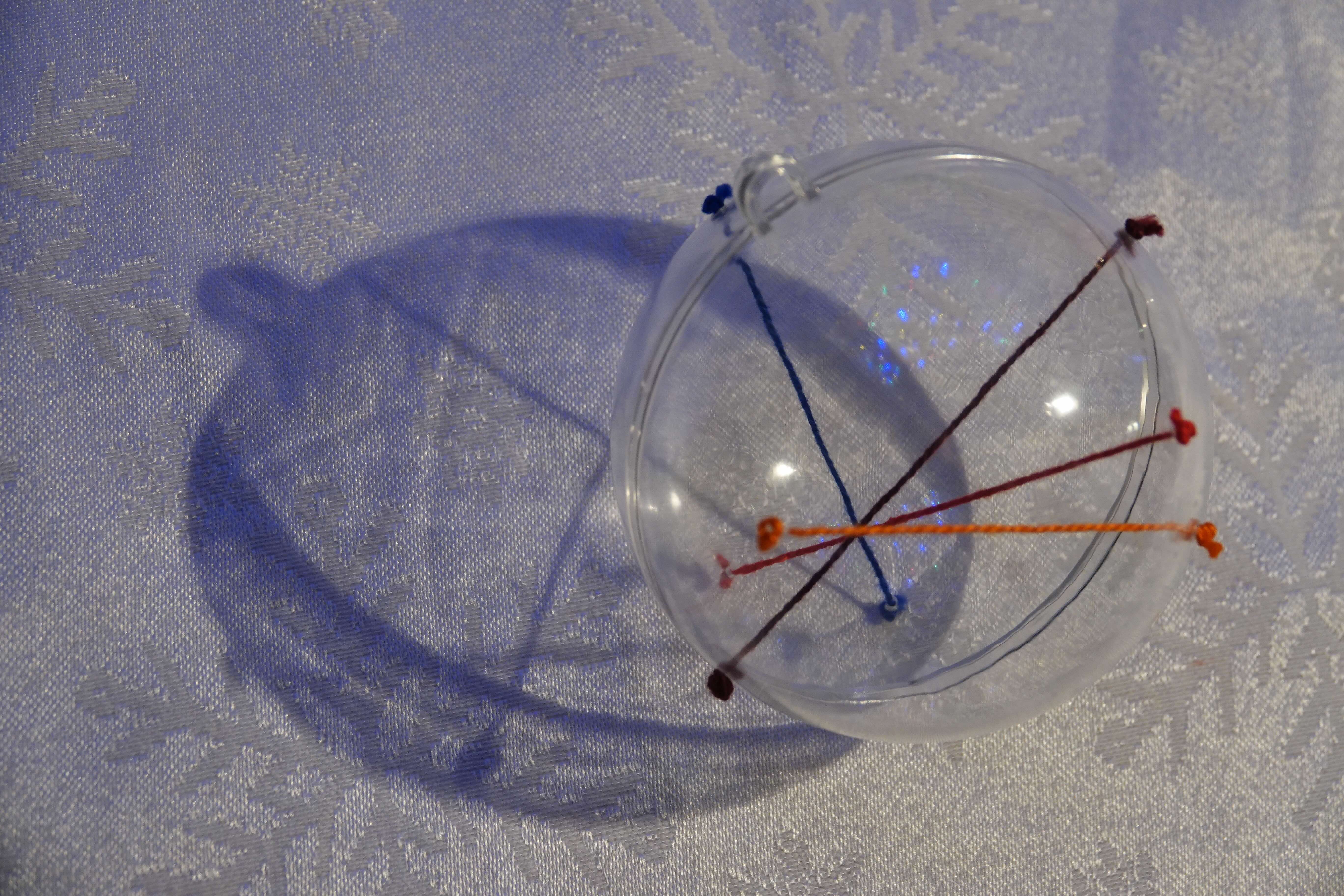 A view of the bauble where the four strings all cross together into a point.