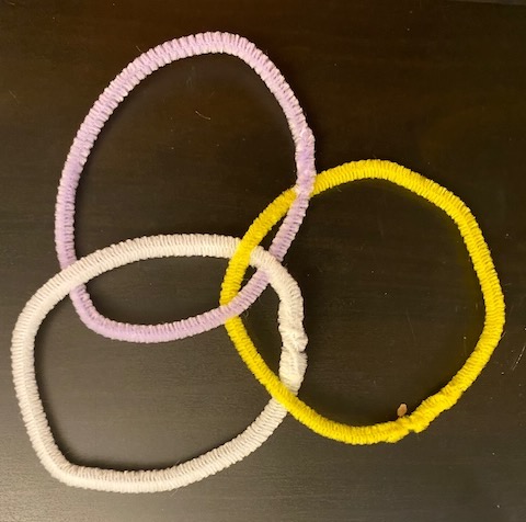 three pipe cleaners, bent into circles, arranged like a venn diagram and woven togehter.t