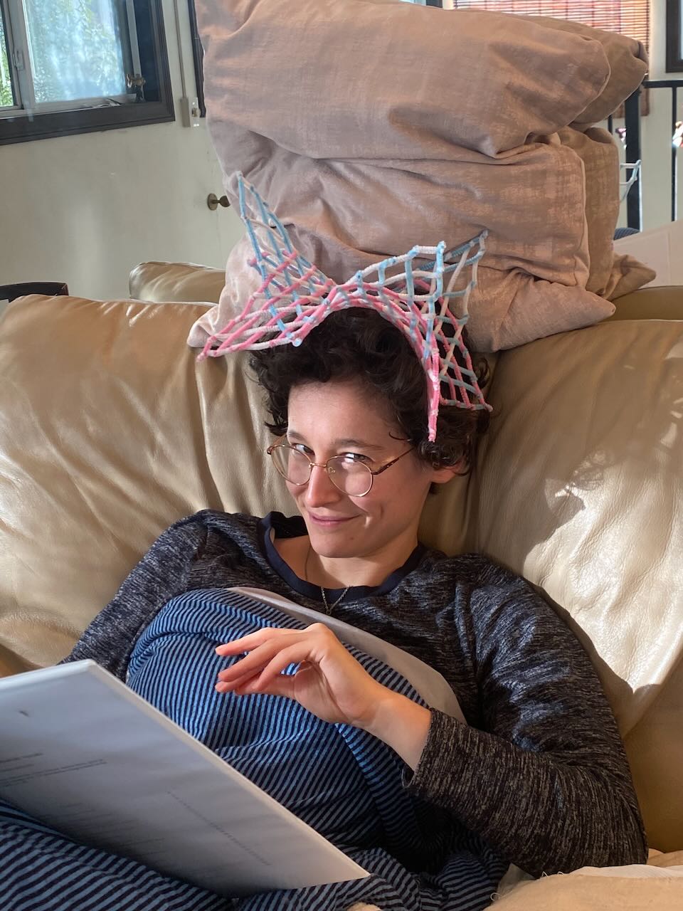 mischevious looking human wearing pipe cleaners as a hat
