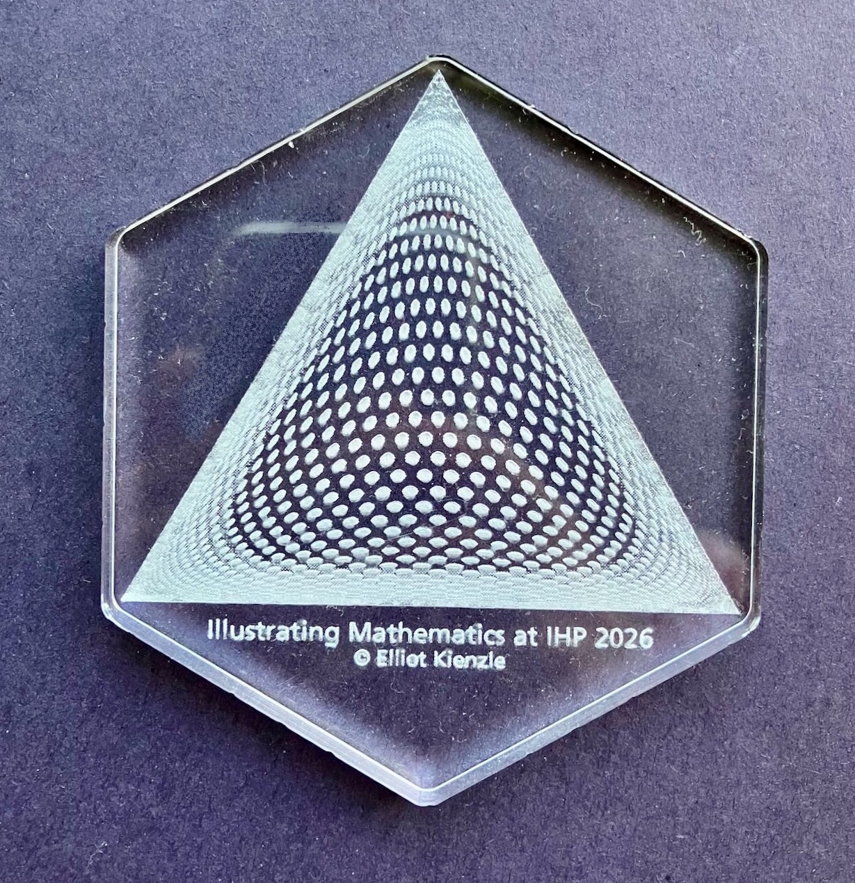 a clear coaster with a white etched picture of the lattice above