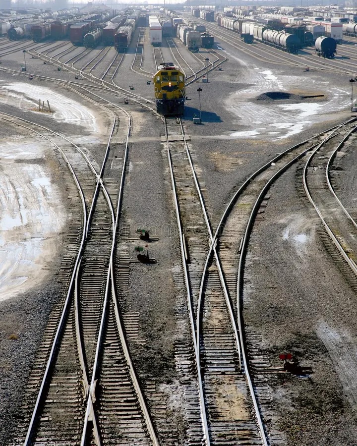 a picture of a sqitch yard, with train tracks merging and splitting