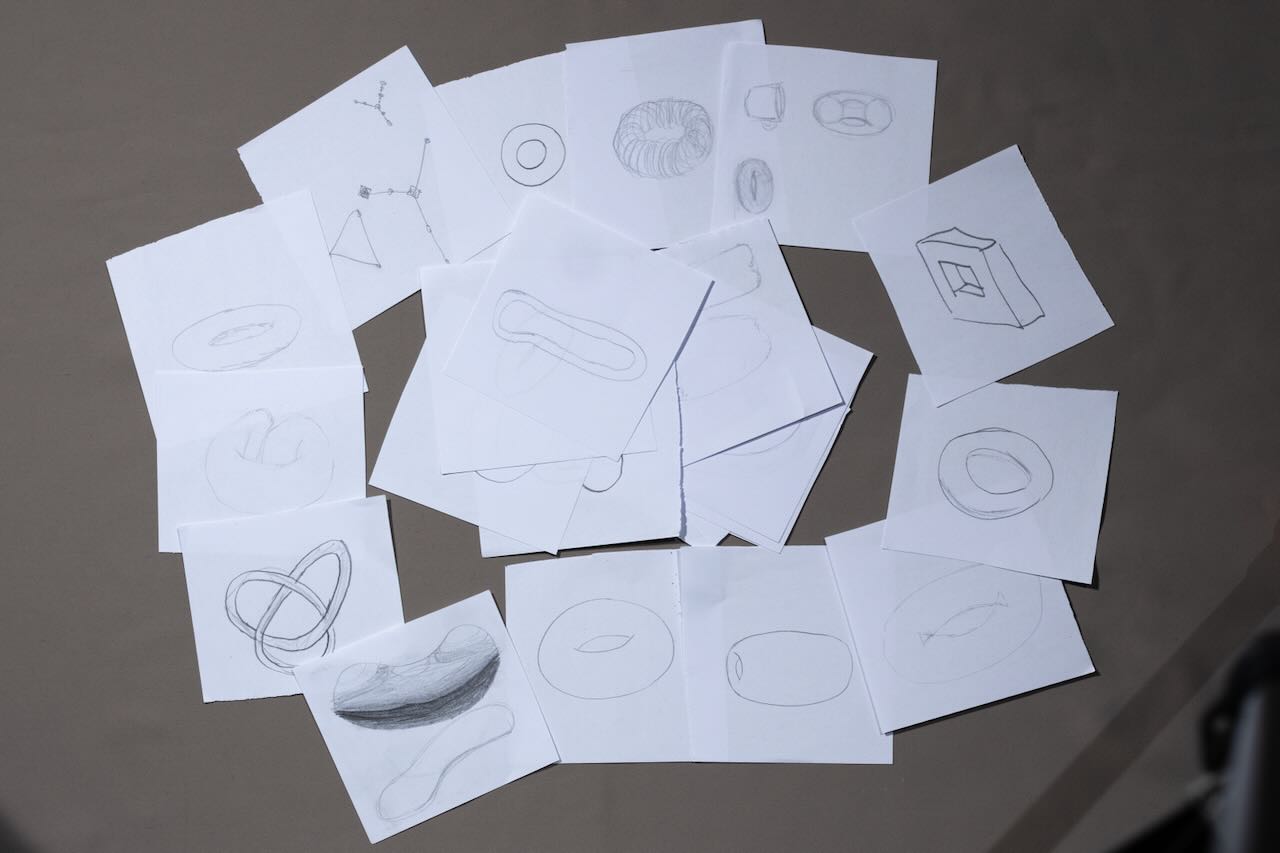 many drawings of tori in a pile