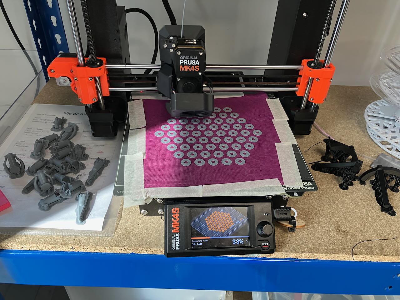 a 3D printer mid print with fabric taped to the print bed.