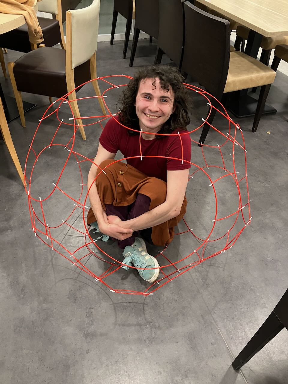 a large polyhedron with elliot sitting inside