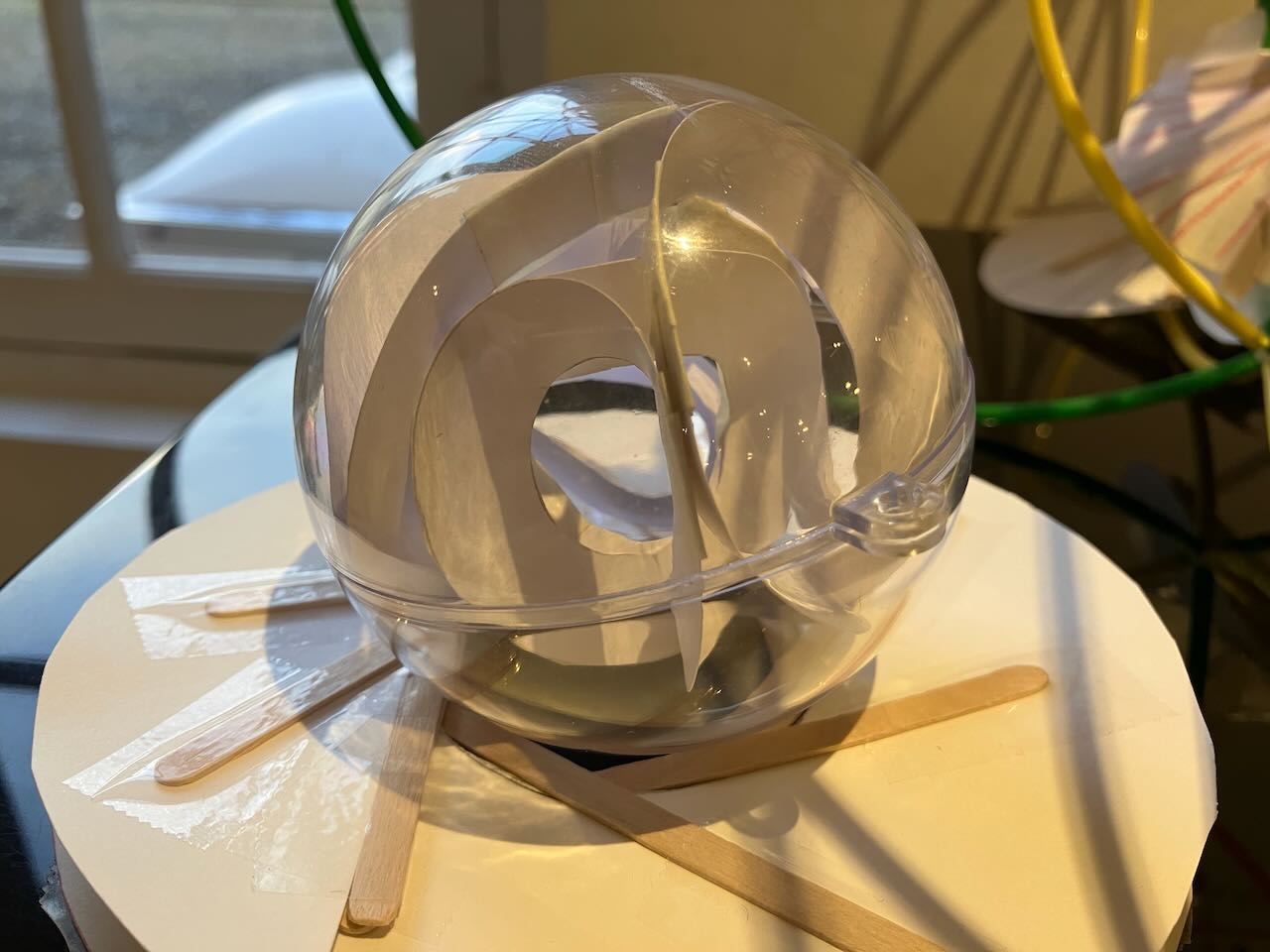 a plastic christmas ornament, full of paper. There s an inner and outer sheet of paper