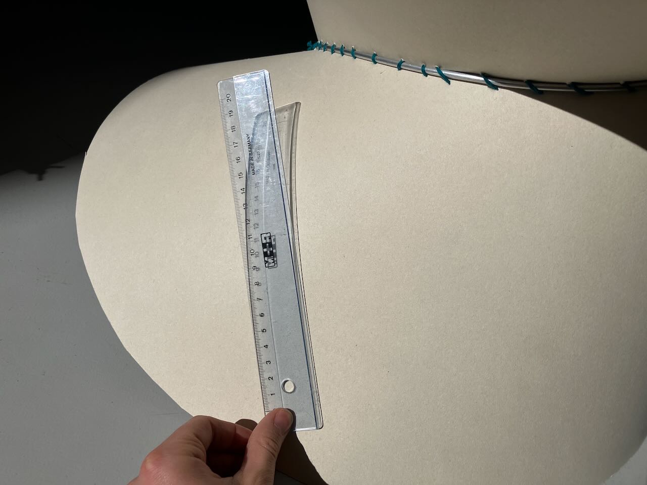 A developable surface with a ruler tangent to a point. This ruler does  NOTlie along the surface.