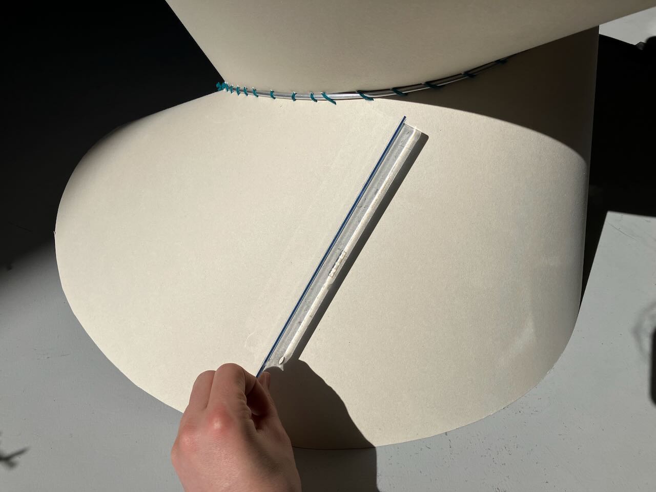 A developable surface with a ruler tangent to a point. This ruler does lie along the surface.