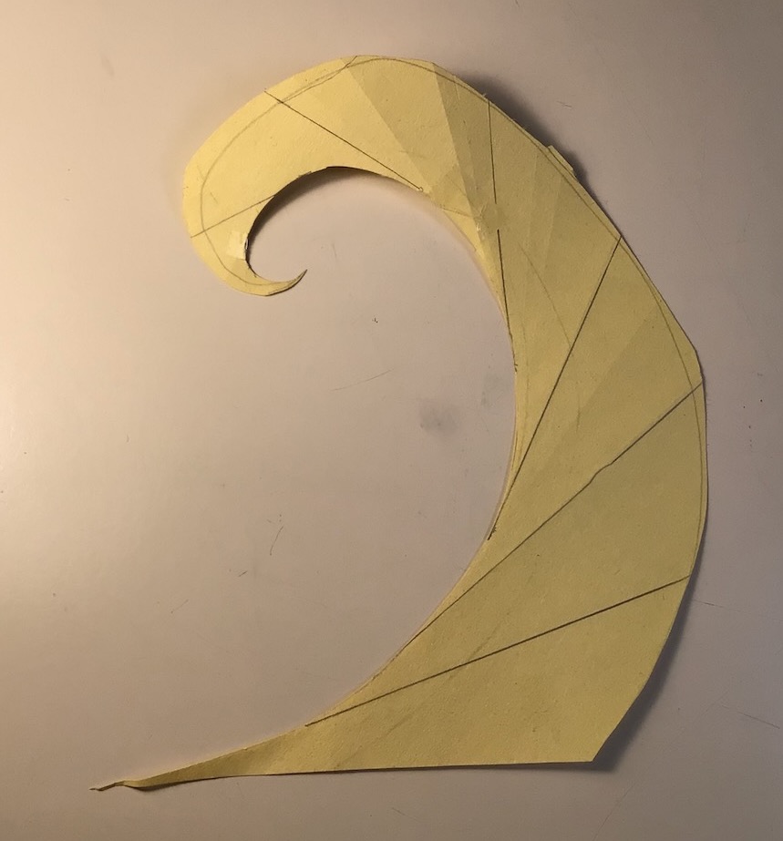 A spiral cut out of paper. The tangents from the inside of the spiral are drawn on the outside