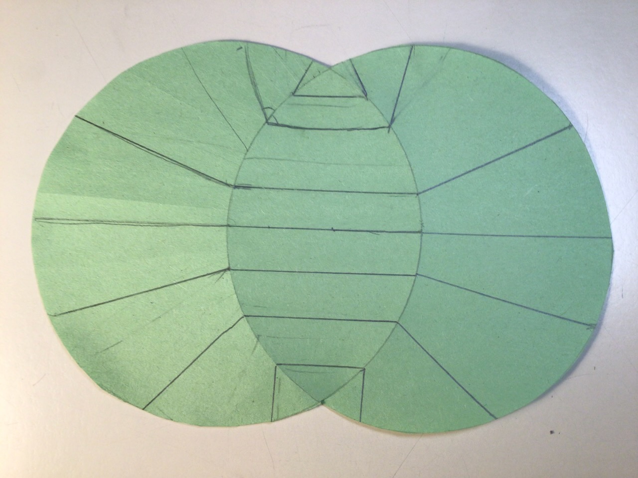 A vesica pisces shape (Two intersecting cirrcles) cut out of paper